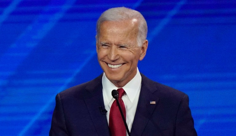 Former Vice President Joe Biden smiles during a debate.