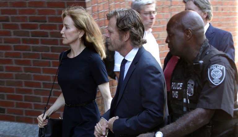 Felicity Huffman arrives at federal court with her husband William H. Macy for sentencing in a nationwide college admissions bribery scandal, Friday, Sept. 13, 2019, in Boston.