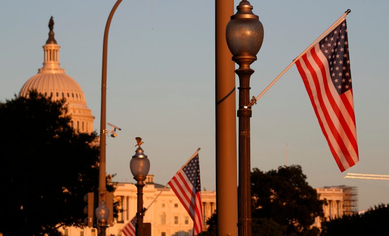 Flags fly at sunset with 51 instead of the usual 50 stars, along Pennsylvania Ave., part of a display in support of statehood for the District of Columbia, Sunday, Sept. 15, 2019, in Washington. 