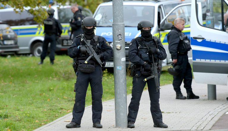 Police officers block a road in Halle, Germany, Wednesday, Oct. 9, 2019. 