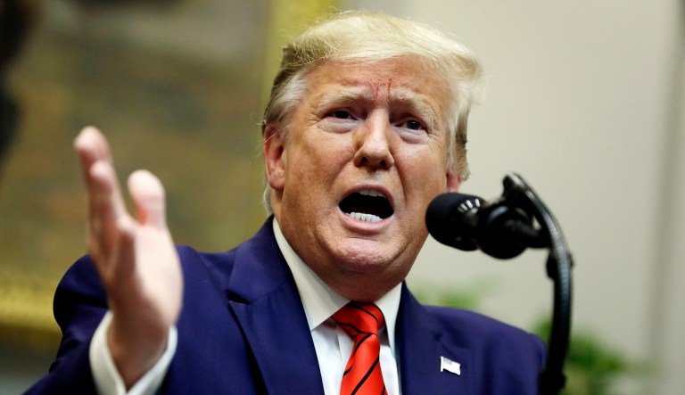 President Trump answers questions from reporters in Washington.