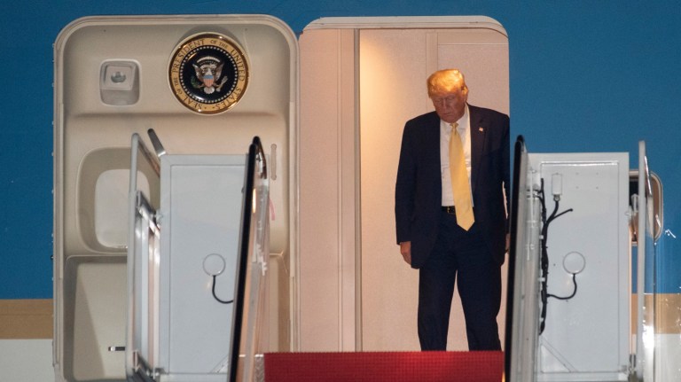 President Trump prepares to depart Air Force One early Saturday, Oct. 12, 2019, at Andrews Air Force Base, Md., after returning from a campaign rally in Louisiana. 