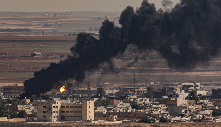 In this photo taken from the Turkish side of the border between Turkey and Syria, in Ceylanpinar, Sanliurfa province, southeastern Turkey, smoke billows from fires on targets in Ras al-Ayn, Syria, caused by bombardment by Turkish forces, Sunday, Oct. 13, 2019. 
