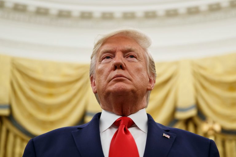 President Donald Trump stands during a Presidential Medal of Freedom ceremony for auto racing great Roger Penske in the Oval Office of the White House, Thursday, Oct. 24, 2019, in Washington.
