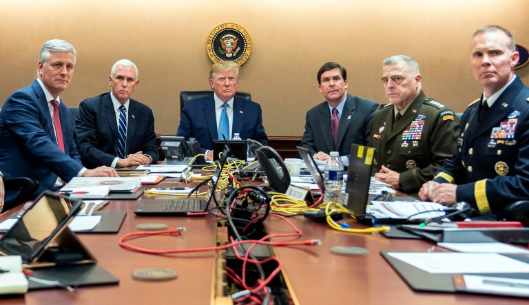 In this photo provided by the White House, President Donald Trump is joined by from left, national security adviser Robert O'Brien, Vice President Mike Pence, Defense Secretary mark Esper, Joint Chiefs Chairman Gen. Mark Milley and  Brig. Gen. Marcus Evans, Deputy Director for Special Operations on the Joint Staff, Saturday, Oct. 26, 2019, in the Situation Room of the White House in Washington. 