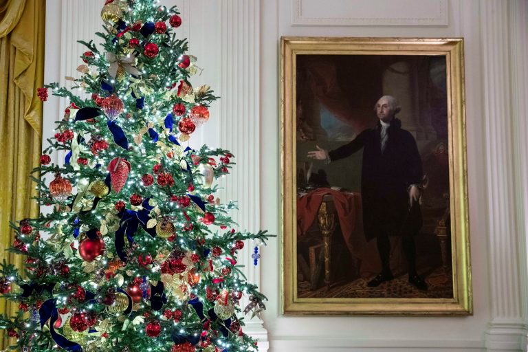 A decorated tree stands next to the portrait of President George Washington in the East Room during the 2019 Christmas preview at the White House, Monday, Dec. 2, 2019, in Washington. A new biography of his mother, Mary Ball Washington, is out Tuesday.