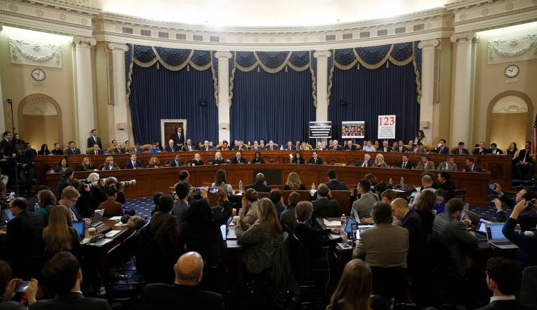 Member of the committee work during a House Judiciary Committee markup of the articles of impeachment against President Trump, Friday, on Capitol Hill in Washington. Trump's impeachment goes to the full House after Judiciary panel approves the charges of abuse of power and obstruction of Congress. 
