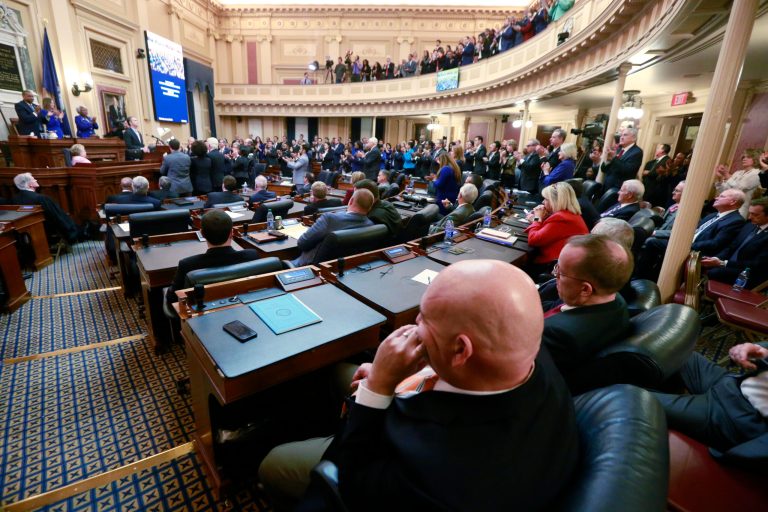 House Republicans sit in their seats as Democratic lawmakers applaud Virginia Gov. Ralph Northam as he delivers his State of the Commonwealth address before a joint session of the Assembly at the state Capitol in Richmond, Va., Wednesday, Jan. 8, 2020. Northam was talking about his gun-control legislation.