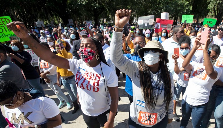 People react during a rally to protest the shooting of Ahmaud Arbery on May 8, 2020, in Brunswick, Georgia. Two men have been charged with murder in the February shooting death of Arbery,Â a black man in his mid-20s, whom they had pursued in a truck after spotting him running in their neighborhood. 