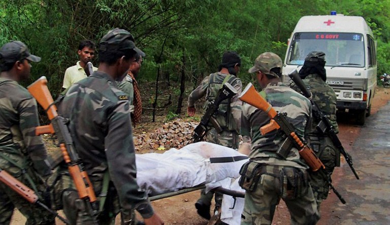 Indian security personnel carry the body of one of the victims of Saturdayâs Maoist attack in a densely forested area in Bastar, about 345 kilometers (215 miles) south of Raipur, Chhattisgarh state, India, Sunday, May 26, 2013. Officials reacted with outrage Sunday to an audacious attack by about 200 suspected Maoist rebels who set off a roadside bomb and opened fire on a convoy carrying Indian ruling Congress party leaders and members in an eastern state, killing at least 24 people and wounding 37 others. 