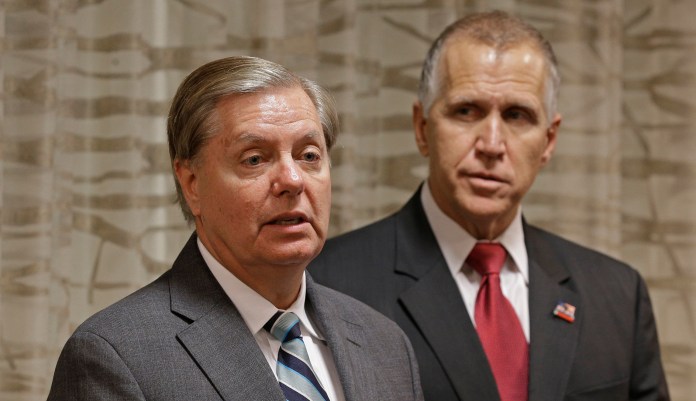 Sen. Lindsey Graham speaks to the media about national security as Sen. Thom Tillis listens. 