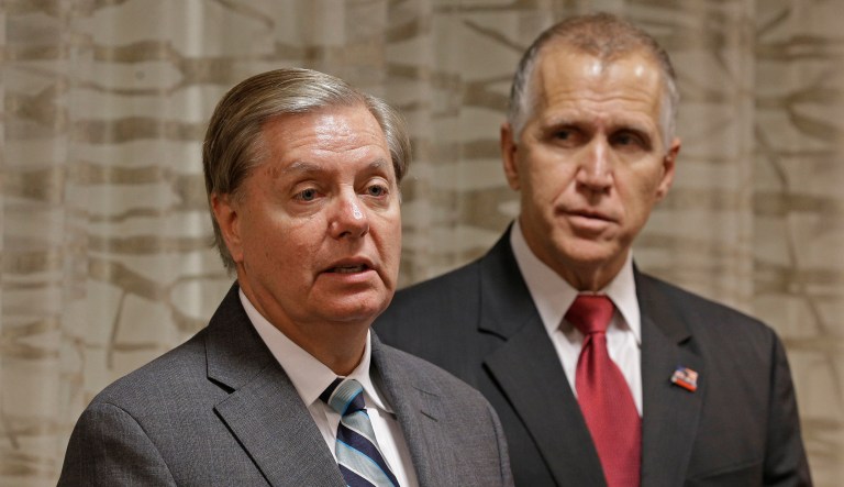 Sen. Lindsey Graham speaks to the media about national security as Sen. Thom Tillis listens. 