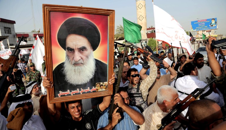 Iraqi Shiite tribal fighters raise their weapons, hold a poster of Grand Ayatollah Ali Sistani, and chant slogans against the al-Qaeda-inspired Islamic State of Iraq and the Levant, after authorities urged Iraqis to help battle insurgents in 2014.