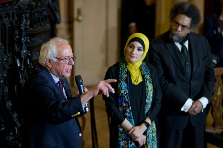 Linda Sarsour, center and Cornel West, right, listen as Democratic presidential candidate Bernie Sanders, I-Vt., speaks in a roundtable discussion at the First Unitarian Congregational Society, Saturday, April 16, 2016, in the Brooklyn borough of New York.