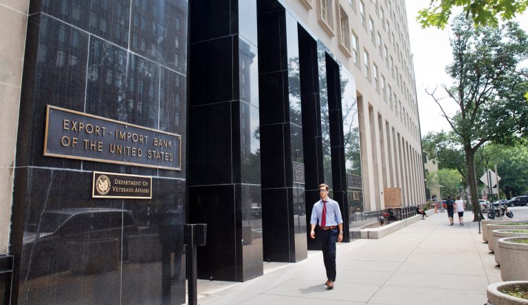 In this photo taken July 28, 2015, a man walks past the Export-Import Bank of the United States, in Washington. 