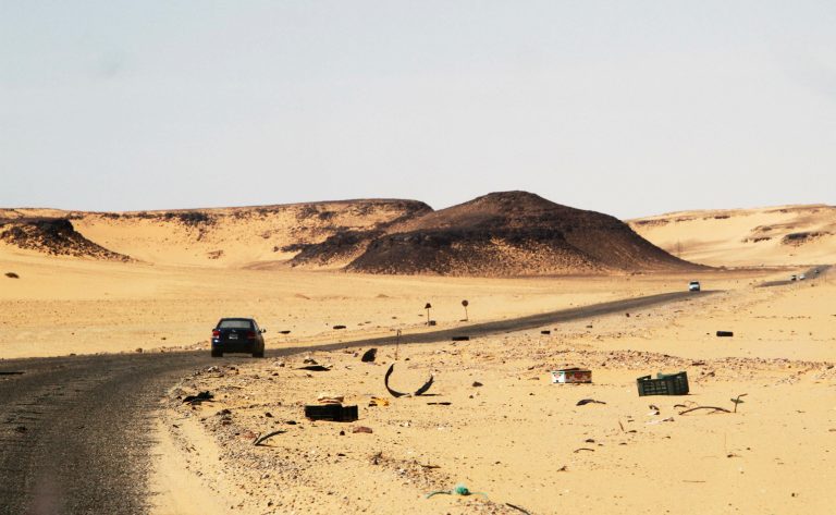 A car drives on a road between Sebha and Ubari in southwestern Libya.