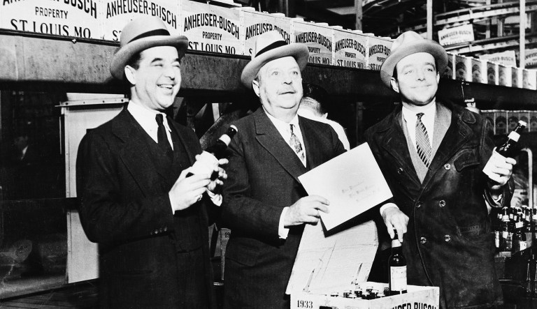 August A. Busch Sr., center, son of the founder of the nation's largest brewery, and his two sons seal the first case of beer off the line for air express delivery to President Franklin D. Roosevelt at the bottling plant of the Anheuser-Busch brewery in St. Louis, Mo., at midnight on the day of the repeal of Prohibition, April 6, 1933.
