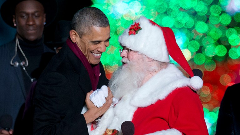 President Barack Obama greets Santa on stage during the National Christmas Tree lighting ceremony.