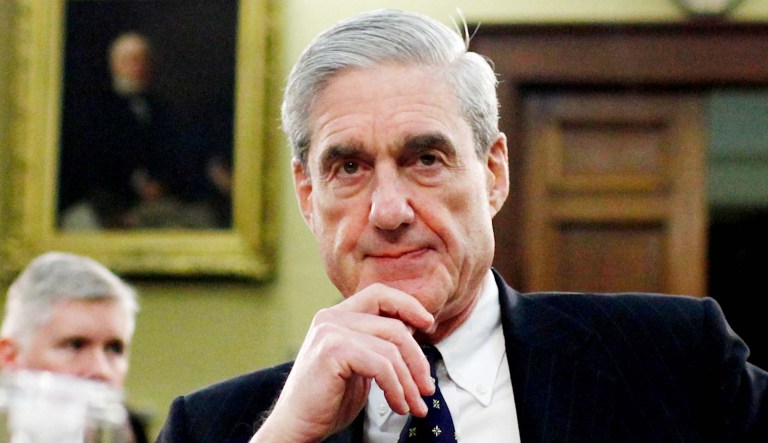 Robert Mueller gestures before a hearing begins on Capitol Hill in Washington.