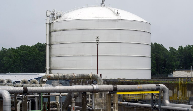 Transfer pipes carry liquified natural gas to and from a holding tank, seen in background, at Dominion Energy's Cove Point LNG Terminal in Lusby, Md., Thursday, June 12, 2014. Federal regulators concluded that Dominion Energy's proposal to export liquefied natural gas from its Cove Point terminal on the Chesapeake Bay in Maryland would pose "no significant impact" on the environment. 
