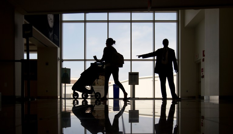 A traveler is directed to a security checkpoint in Terminal A at Ronald Reagan Washington National Airport in Arlington, Va.