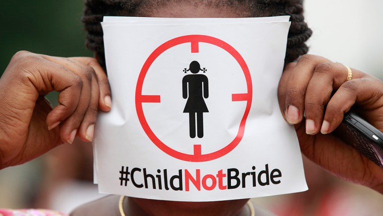 In this photo taken on Saturday, July 20, 2013, a woman protests against underage marriages in Lagos, Nigeria.
