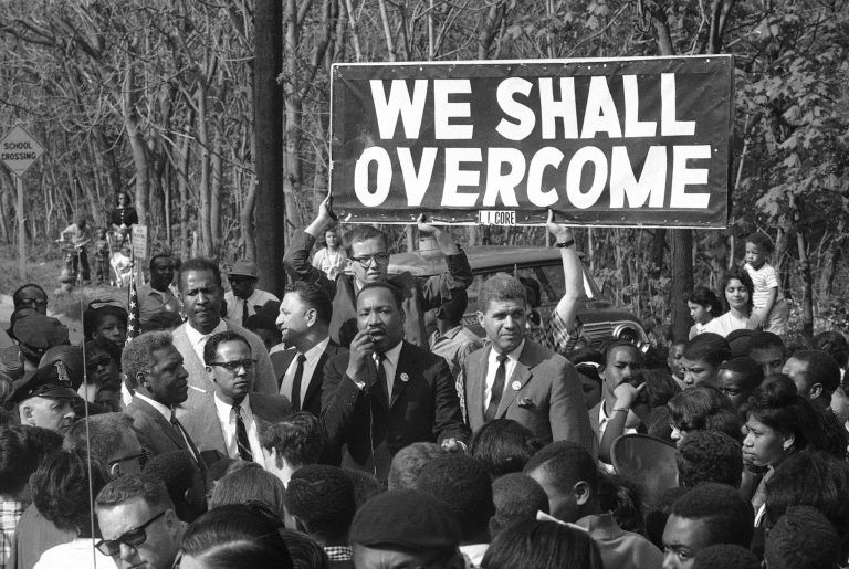 The Rev. Martin Luther King, integration leader, addresses a crowd on a street in Lakeview, New York May 12, 1965. The Nobel Prize winner arrived in the day from Atlanta, Ga., for a whirlwind tour of Nassau County to advance the cause of African Americans in that area.