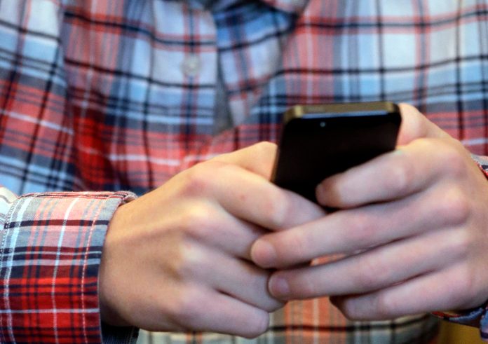This photo shows a person checking his smartphone.