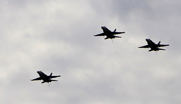 An F-18 fighter jet peels away in the missing man formation as they fly over private services for astronaut Neil Armstrong, Friday, Aug. 31, 2012, at the Camargo Country Club in Cincinnati. Hundreds of people attended a closed service for Armstrong Friday at a private club in suburban Cincinnati. A national memorial service has been scheduled for Sept. 12 in Washington.