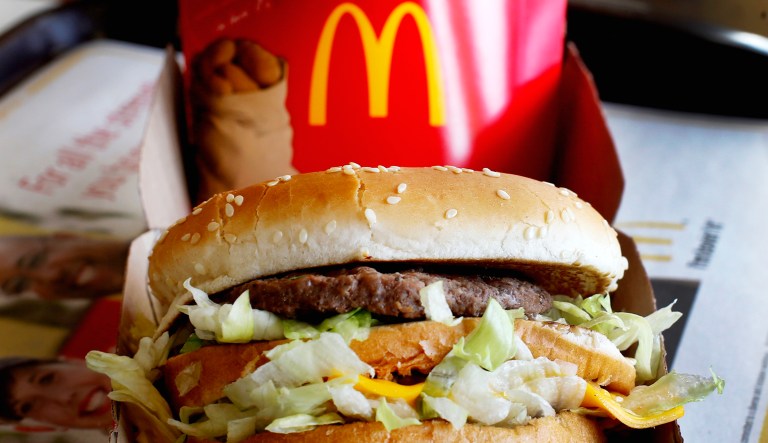 A Big Mac is shown with some fries from McDonald's.