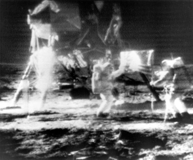 Astronauts Neil Armstrong, left, and Edwin E. Aldrin, Jr., place an American flag on the surface of the moon Sunday July 20, 1969, near the lunar lander that brought them to the lunar surface.