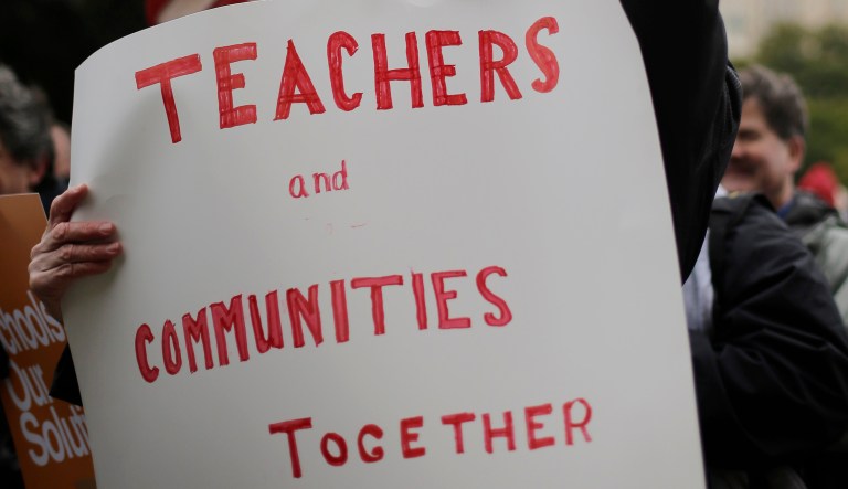 Teacher George Sheridan and other supporters of public education take part in a rally on the steps of the state Capitol, Friday, Dec. 6, 2013, in Austin, Texas. The Texas affiliate of the National Education Association and other advocacy groups have issued failing grades to U.S. Sens. John Cornyn and Ted Cruz on key social and educational issues. 