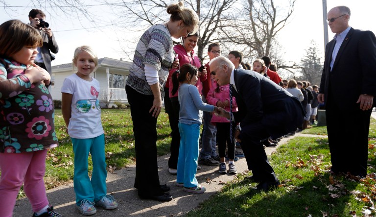 Vice President Joe Biden talks to a young girl as he met with students outside two schools, Thursday, Nov. 1, 2012, in Muscatine, Iowa, after a campaign stop.