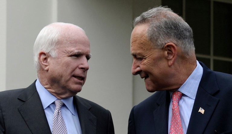 Sen. John McCain, R-Ariz., left, and Sen. Chuck Schumer, D-N.Y., walk outside of the West Wing of the White House in Washington.