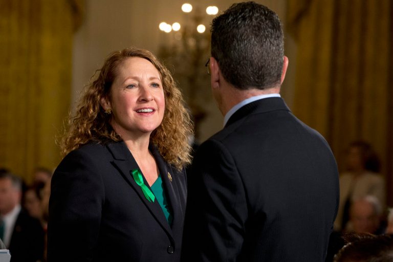 Rep. Elizabeth Esty, D-Conn., left, speaks with Connecticut Gov. Dannel Malloy, in the East Room of the White House in Washington, Tuesday, Jan. 5, 2016, about steps his administration is taking to reduce gun violence. Also on stage are stakeholders, and individuals whose lives have been impacted by the gun violence.