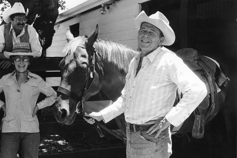 FILE - In this June 28, 1976, file photo Ronald Reagan poses with his horse before taking a ride around his ranch, Rancho del Cielo, near Santa Barbara, Calif.  At left, first lady Nancy Reagan. After becoming president Reagan frequently flew cross-country on Air Force One to his beloved California ranch, where he could chop wood and clear brush. There just wasn't enough physical labor, he said, at the Camp David presidential retreat in Maryland's mountains, a short helicopter ride from the White House.