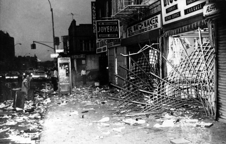 This is a scene along Utica Ave., in Brooklyn during New York City's electrical power outage on Thursday, July 14, 1977.  In one three-block length virtually every store had its windows smashed and its contents looted in the aftermath of the blackout July 13.