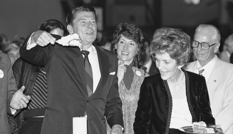 Republican presidential candidate Ronald Reagan holds a piece of birthday cake high during birthday party for the former California governor in Los Angeles on Sunday, Feb. 3, 1980.