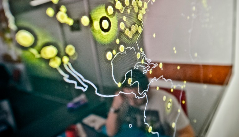 A map of the United States is displayed on a computer screen shows cyberattacks in real time at the headquarters of a cybersecurity company.