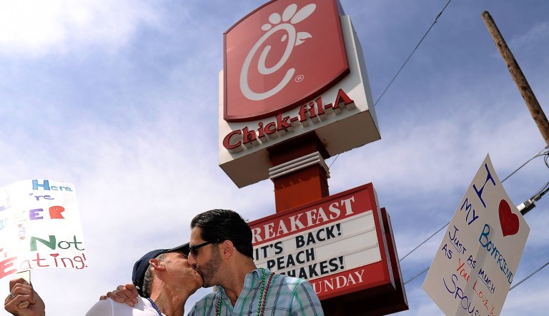 Jim Fortier, left, and Mark Toomajian, kiss as they join about two dozen members of gay rights groups and others protesting outside the Decatur, Ga., Chick-fil-A restaurant Friday, Aug. 3, 2012. 