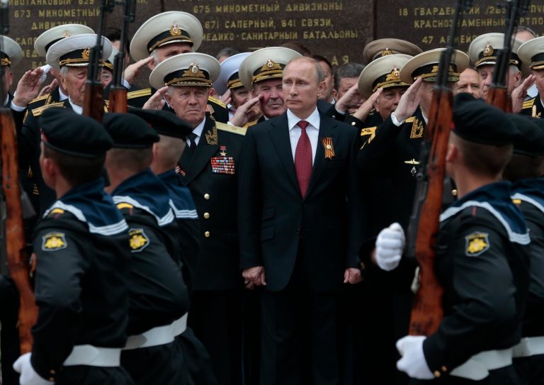 Russian President Vladimir Putin attends a  parade marking the Victory Day in Sevastopol, Crimea, Friday, May 9, 2014. Crimea, which hosts a major Russian Black Sea Fleet base, is set to hold a massive navy parade in the port of Sevastopol. Putin extolled the return of Crimea to Russia before tens of thousands Friday during his first trip to Black Sea peninsula since its annexation.