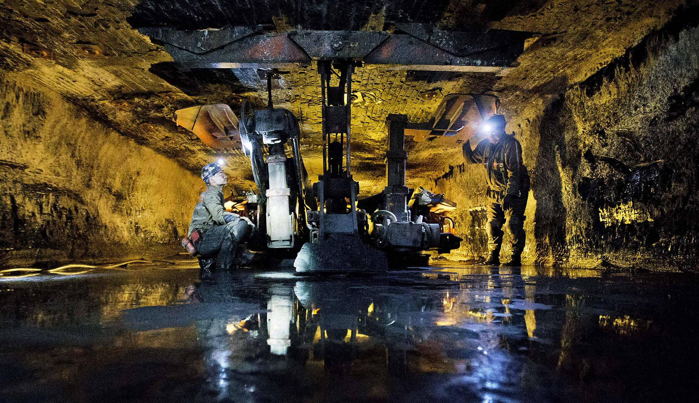 James Phillips (left) and Chad Cordill (right) use a roof bolting machine to secure with roof of the Sewell "R" coal mine in Yukon, W.Va. 