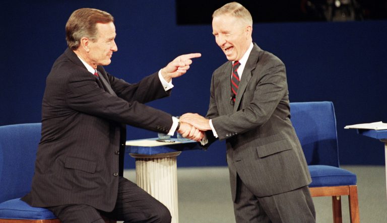 President George Bush, left, and independent candidate Ross Perot say good-bye to each other at the end of presidential debate in Richmond, Virginia, Thursday, Oct. 15, 1992. 