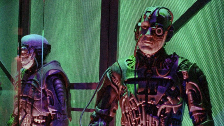 A worker puts the finishing touches on a display of Borg, which lines the walls at Star Trek.