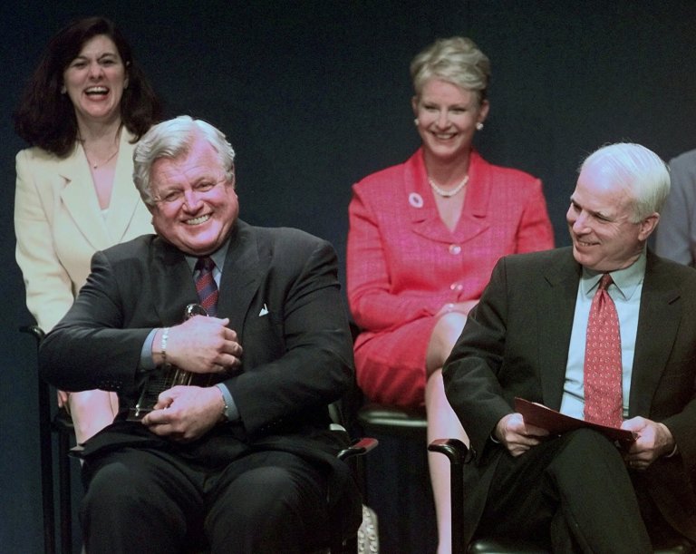On May 24, 1999, the late Sen. Edward Kennedy, D-Mass., jokingly holds the Profile in Courage award lantern as if he intends to keep it, as co-winner, Senator John McCain, R-Ariz., looks on at right during ceremonies at the John F. Kennedy Library in Boston.