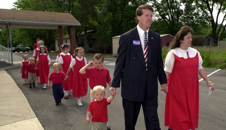 Arkansas state Rep. Jim Bob Duggar of Springdale front center, and his wife Michelle, right, lead twelve of their thirteen children to a polling place in Springdale, Ark., in this Tuesday, May 21, 2002 file photo. Duggar was running for the U.S. Senate against incumbant Tim Hutchinson in the republican primary election. Dugger's sons Jason, 2, is pictured left, followed by Josiah, 5.