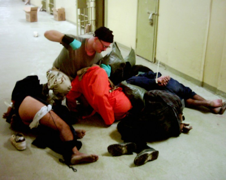 Cpl. Charles A. Graner Jr. appearing to punch one of several handcuffed detainees lying on the floor in late 2003 at the Abu Ghraib prison in Baghdad, Iraq. Graner was later convicted of offenses that included stacking the prisoners into a pyramid, knocking one of them out with a head punch and ordering prisoners to masturbate while soldiers took pictures. He was released Saturday, Aug. 6, 2011 from a military prison after serving more than 6Â½ years of a 10-year sentence, an Army spokeswoman said. 