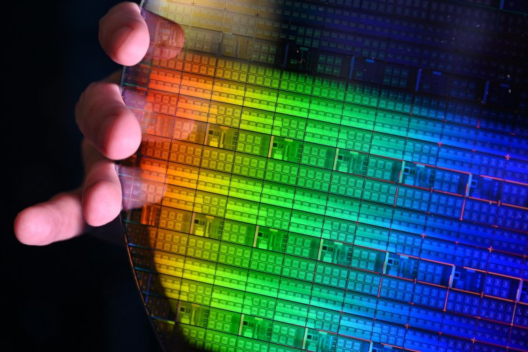 A photo shows Intel's fully processed 30-millimeter silicon spin qubit wafer.