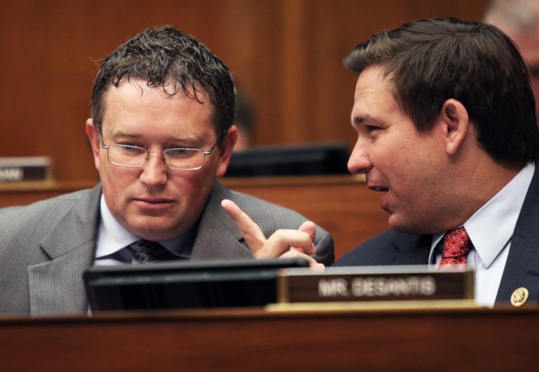 House Committee on Oversight and Government Reform members, Rep. Tom Massie, R-Ky., left, and Ron DeSantis, R-Fla. talk on Capitol Hill in Washington, Wednesday, June 15, 2016, during the committee's hearing to consider a censure of IRS Commissioner John Koskinen. 