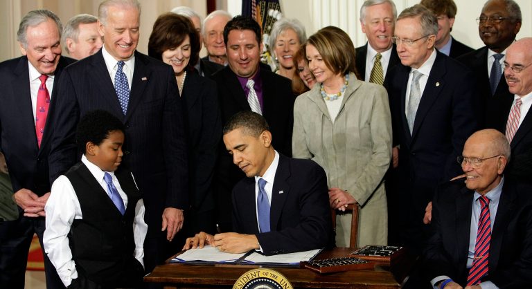 In this March 23, 2010, photo, President Barack Obama signs the health care bill in the East Room of the White House in Washington.